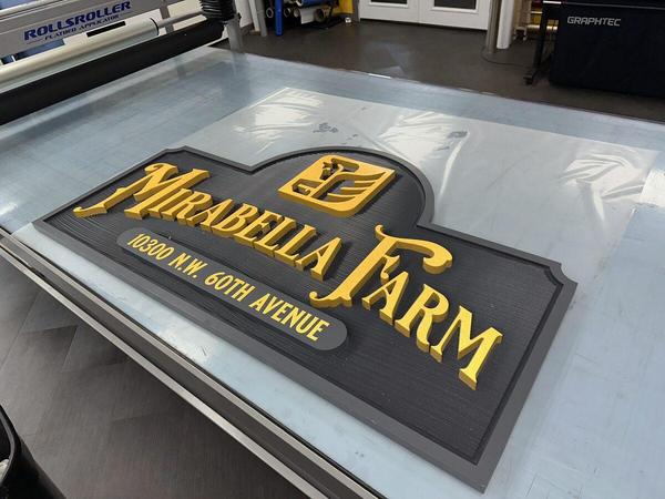 Carved HDU sign with textured background, raised letters, painted finish, and reflective vinyl accents — Custom Graphics & Sign Designs